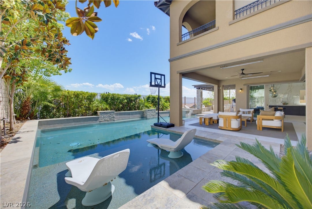 446 Bosco Di Fiore Street, Las Vegas, NV 89138 A resort-style swimming pool meets an inviting covered patio ideal for outdoor relaxation.