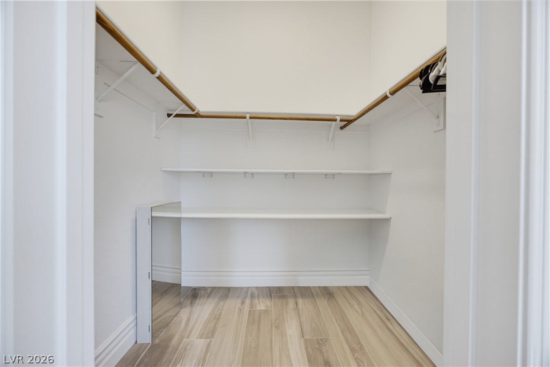 446 Bosco Di Fiore Street, Las Vegas, NV 89138 Ample built-in shelving and wrap-around hanging rods maximize storage in this walk-in closet.
