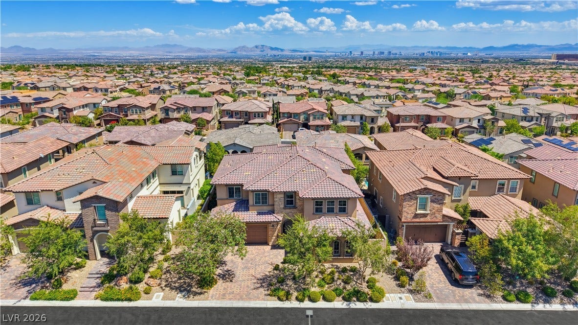 446 Bosco Di Fiore Street, Las Vegas, NV 89138 An elevated perspective showcases the tiled rooftops and desert vistas of a quiet suburban community.
