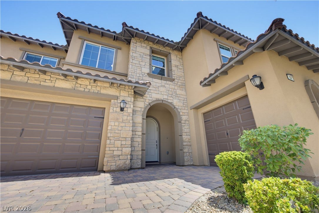 446 Bosco Di Fiore Street, Las Vegas, NV 89138 Elegant stone accents and Spanish tile roofing define this impressive two-story residence facade.