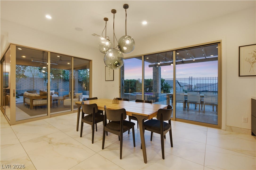446 Bosco Di Fiore Street, Las Vegas, NV 89138 Gleaming tile floors and massive sliding glass doors define this open dining area.