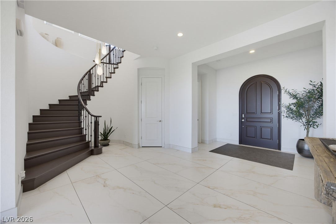 446 Bosco Di Fiore Street, Las Vegas, NV 89138 Polished tile flooring and an elegant curved staircase welcome guests into the spacious foyer.