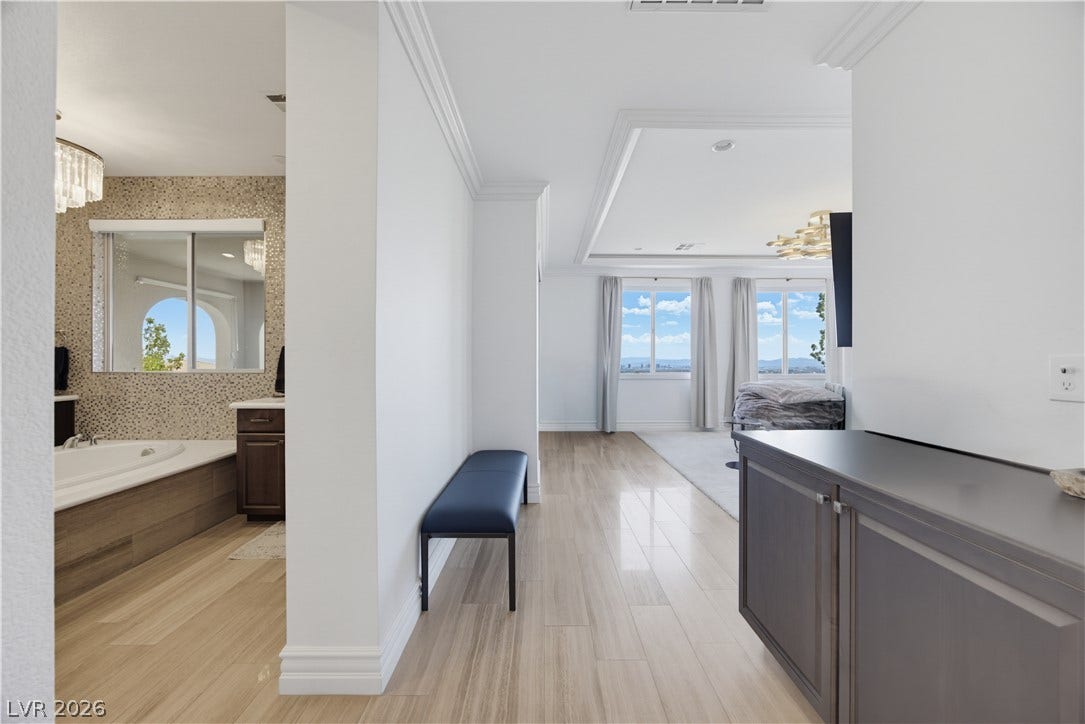 446 Bosco Di Fiore Street, Las Vegas, NV 89138 Gleaming hardwood floors and classic crown moldings flow seamlessly between the elegant master bedroom suite.