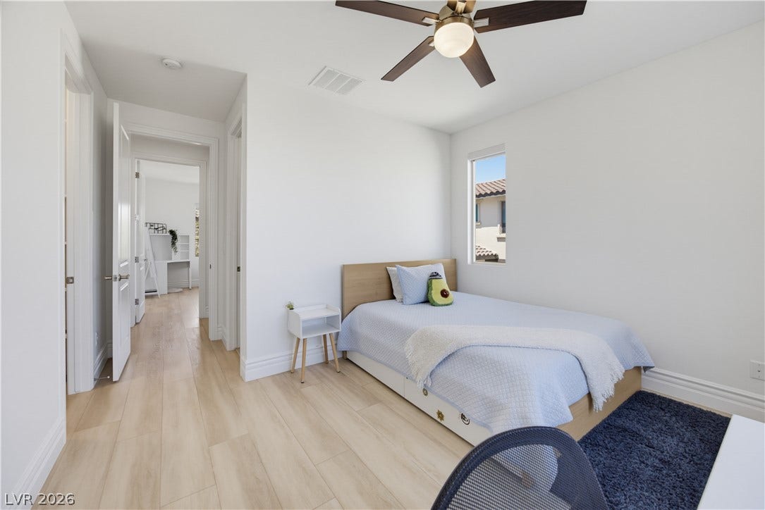 446 Bosco Di Fiore Street, Las Vegas, NV 89138 Smooth wood flooring sweeps through a serene bedroom illuminated by natural light.