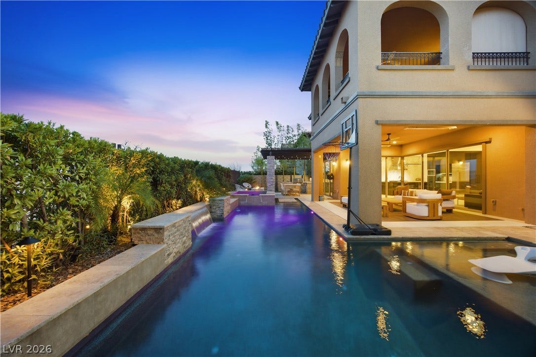 446 Bosco Di Fiore Street, Las Vegas, NV 89138 An elegant outdoor pool is flanked by lush landscaping and a covered patio area.