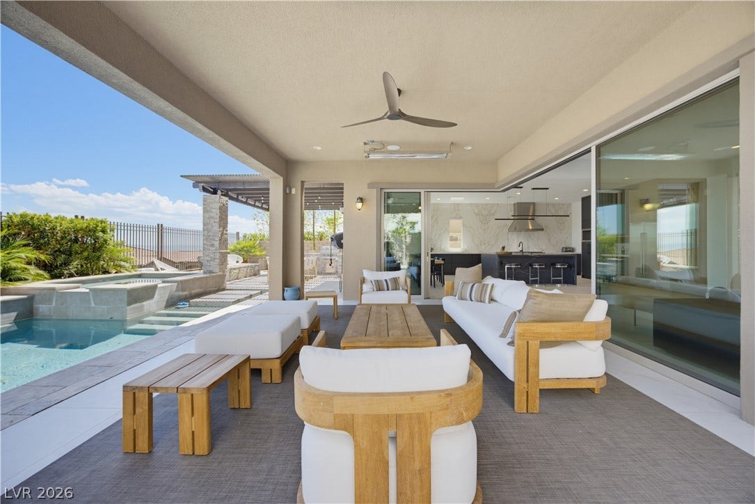 446 Bosco Di Fiore Street, Las Vegas, NV 89138 A covered concrete terrace integrates indoor living with the adjacent swimming pool.