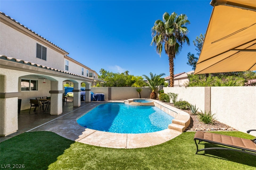 236 Fox Lake Avenue, Las Vegas, NV 89148 A sparkling swimming pool highlights this backyard space complete with a covered patio.