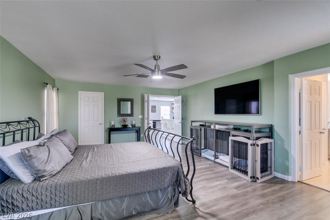 236 Fox Lake Avenue, Las Vegas, NV 89148 A spacious bedroom features neutral plank flooring and smooth walls under a classic flat ceiling.