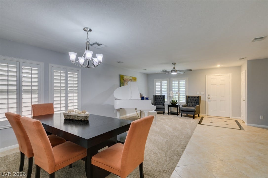 236 Fox Lake Avenue, Las Vegas, NV 89148 Gleaming tile transitions to soft carpet in this light-filled dining and living layout.