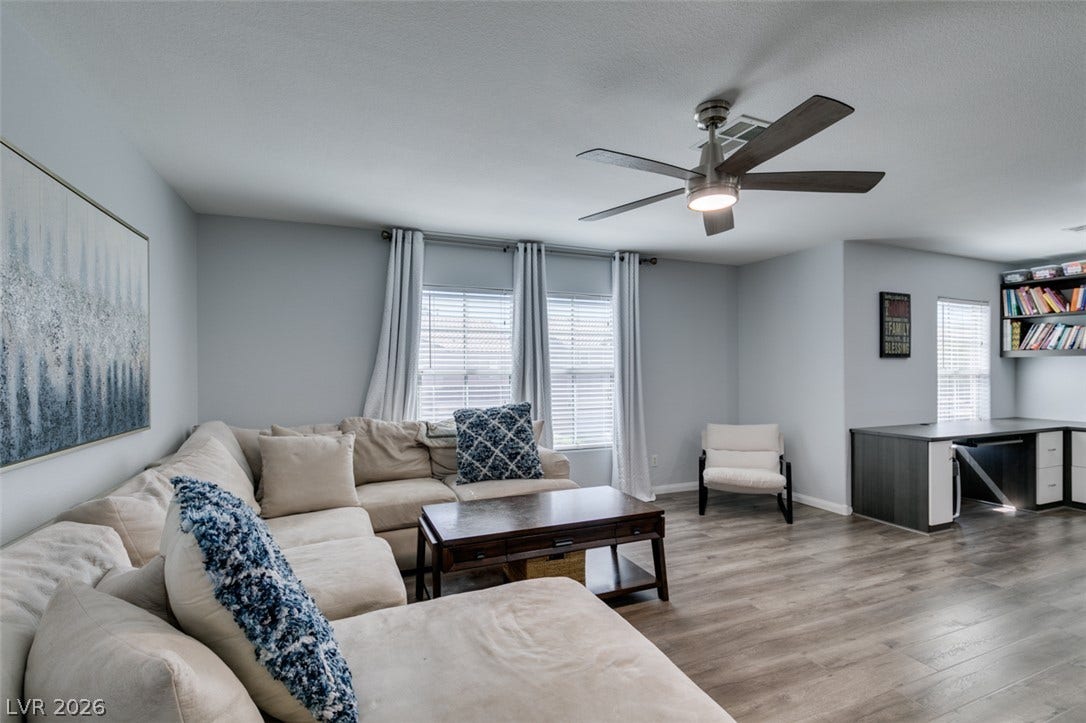 236 Fox Lake Avenue, Las Vegas, NV 89148 Smooth wood-style flooring runs through this versatile living area featuring an integrated study space.