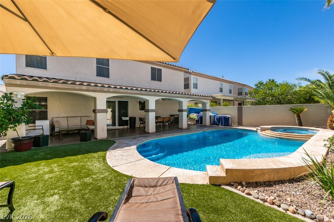 236 Fox Lake Avenue, Las Vegas, NV 89148 A sparkling swimming pool highlights this backyard oasis complete with a shaded covered patio.