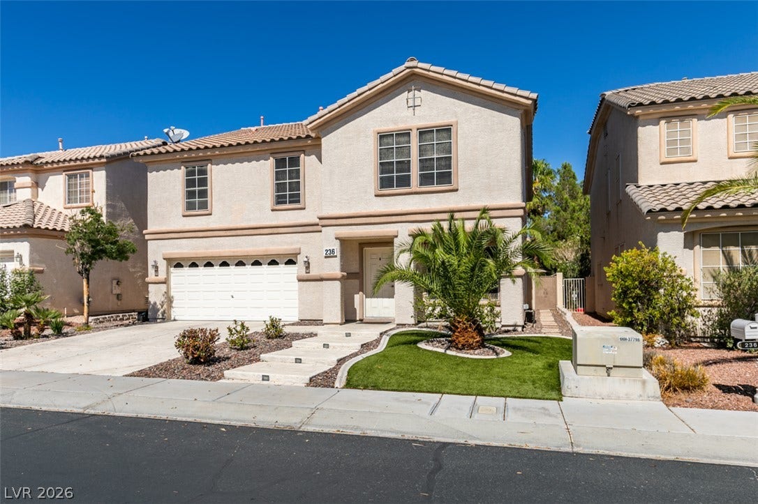 236 Fox Lake Avenue, Las Vegas, NV 89148 Tiled rooflines and stucco siding define this two-story exterior featuring a double garage.