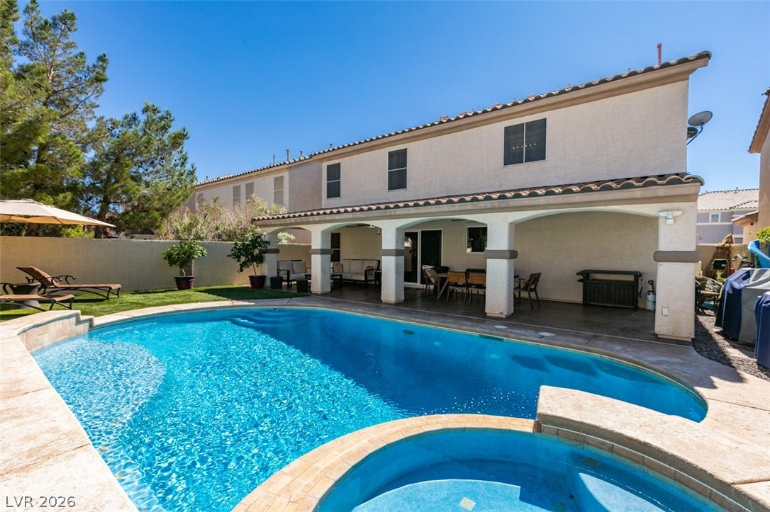 236 Fox Lake Avenue, Las Vegas, NV 89148 A sparkling swimming pool highlights this rear yard complete with a covered patio.