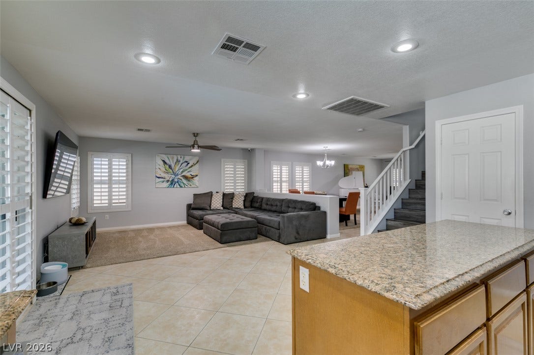 236 Fox Lake Avenue, Las Vegas, NV 89148 An open floorplan seamlessly connects the tiled kitchen area to a spacious living room.