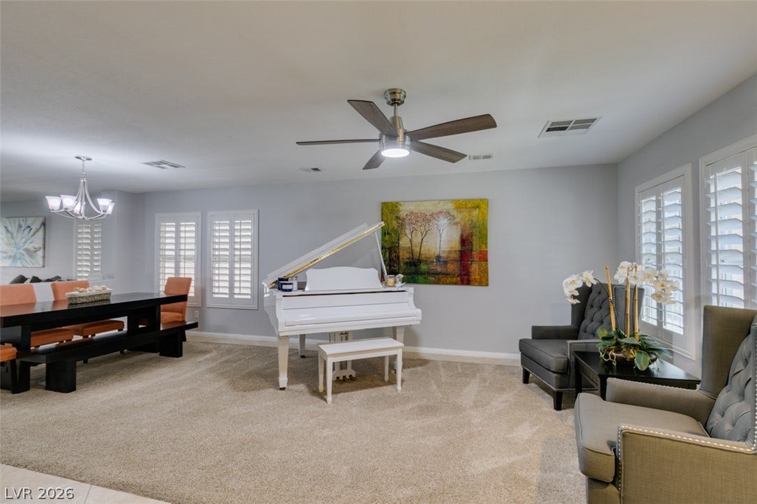 236 Fox Lake Avenue, Las Vegas, NV 89148 Plush carpeting anchors this versatile living space featuring plantation shutters and an open floorplan layout.