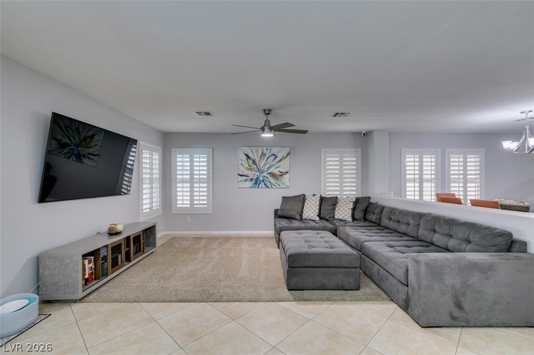236 Fox Lake Avenue, Las Vegas, NV 89148 An open floorplan living space features clean tile flooring and built-in plantation shutters.