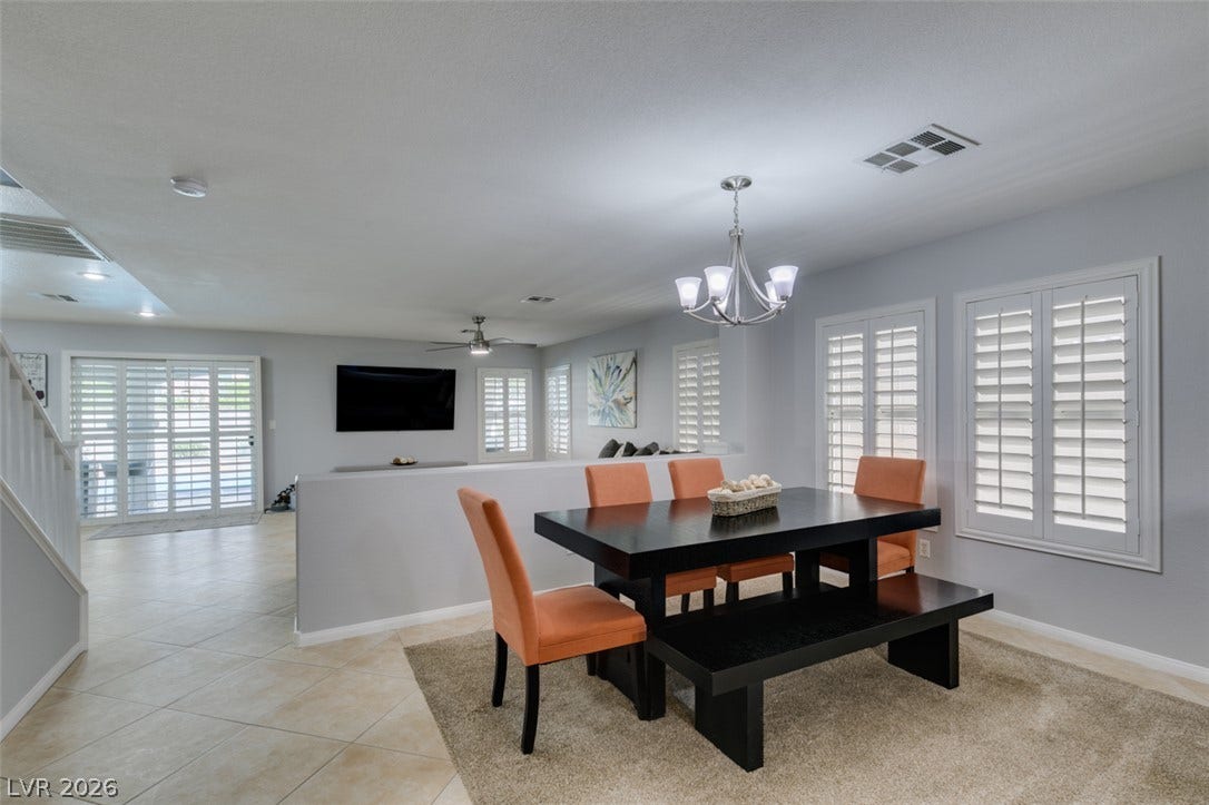 236 Fox Lake Avenue, Las Vegas, NV 89148 An open dining area showcases sleek tile flooring, structured half-walls, and classic plantation shutters.