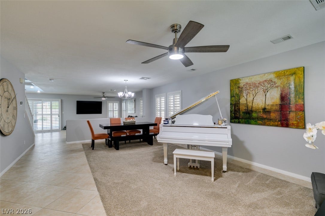 236 Fox Lake Avenue, Las Vegas, NV 89148 An open layout connects the tiled entryway directly to the carpeted dining and living spaces.