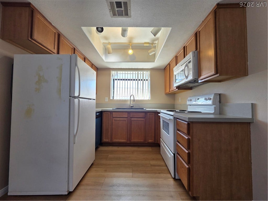 7300 Pirates Cove Road, #2060, Las Vegas, NV 89145 Rich wood cabinetry and ample counter space define this classic kitchen layout.