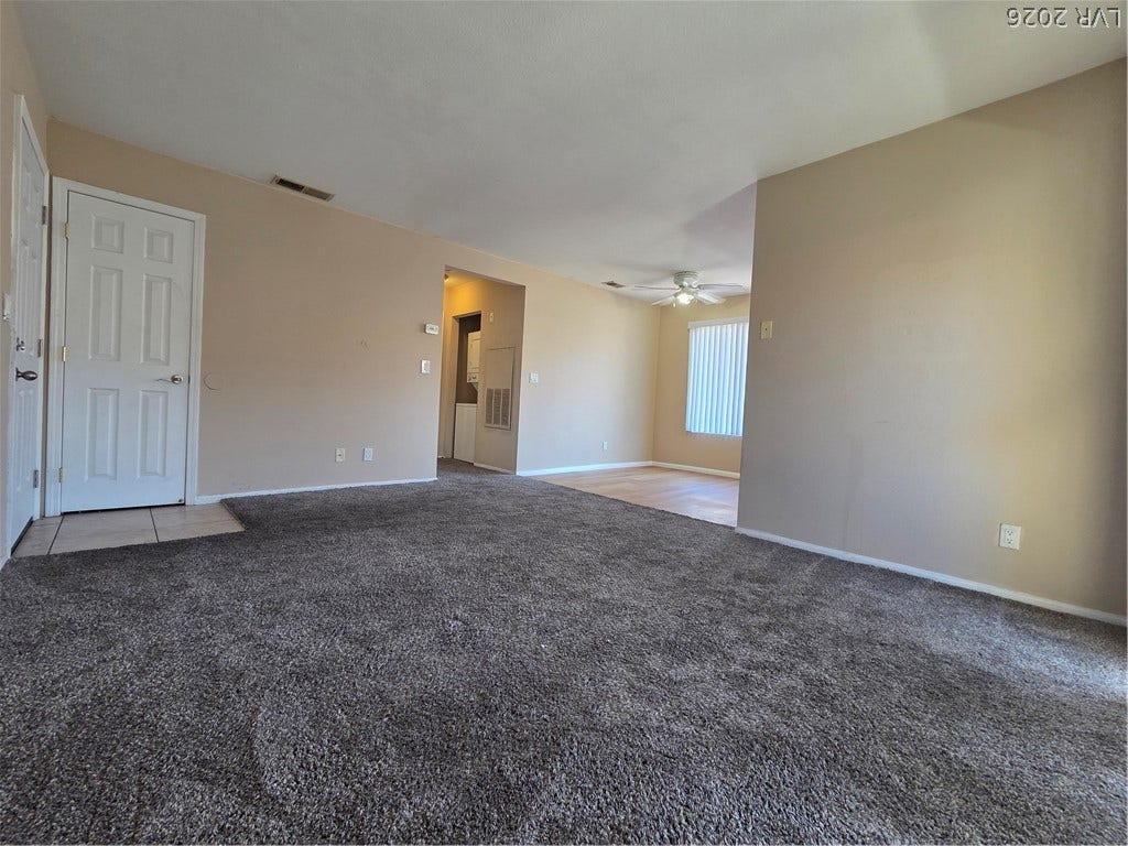 7300 Pirates Cove Road, #2060, Las Vegas, NV 89145 Plush carpeting anchors this versatile recreation space featuring an open-concept flow to adjacent rooms.