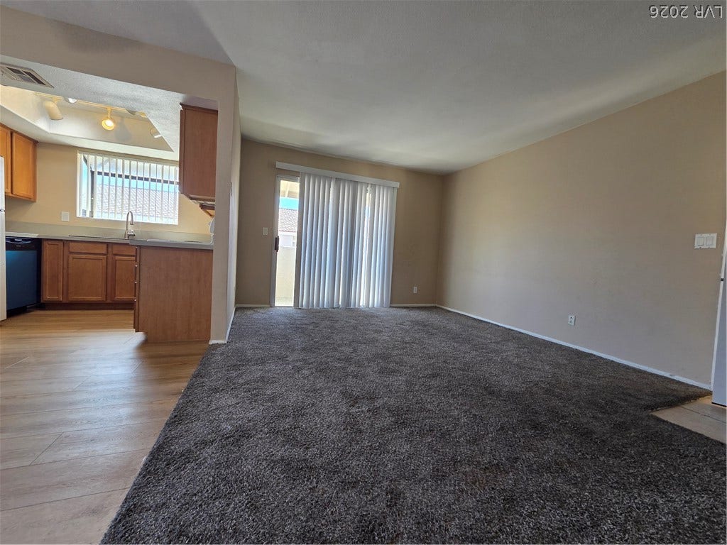 7300 Pirates Cove Road, #2060, Las Vegas, NV 89145 Plush carpeting and an open-concept flow to the adjacent kitchen define this comfortable living space.