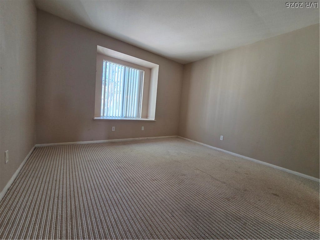 7300 Pirates Cove Road, #2060, Las Vegas, NV 89145 A deep window well and textured ceiling treatment define this simple bedroom space.