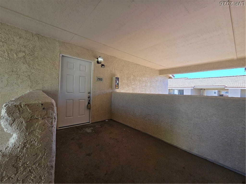 7300 Pirates Cove Road, #2060, Las Vegas, NV 89145 A private entry landing features durable concrete flooring under a protective overhang.