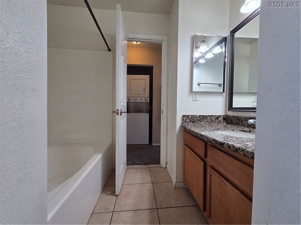 7300 Pirates Cove Road, #2060, Las Vegas, NV 89145 Natural granite counters and classic wood cabinetry enrich this functional bathroom space.