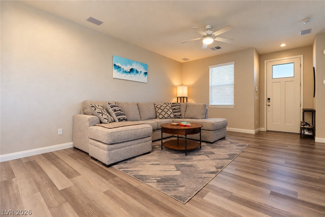 Gleaming wood-look floors anchor a welcoming living space directly off the main entryway.