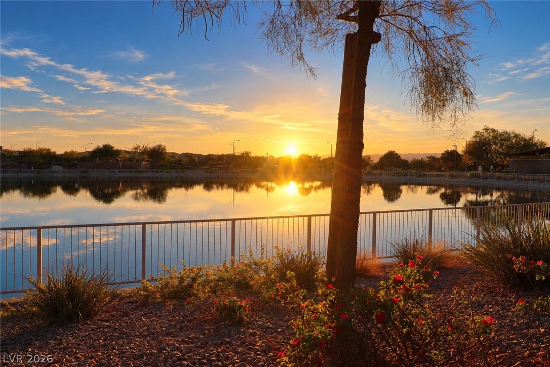Golden sunset light reflects beautifully across the calm community lake.