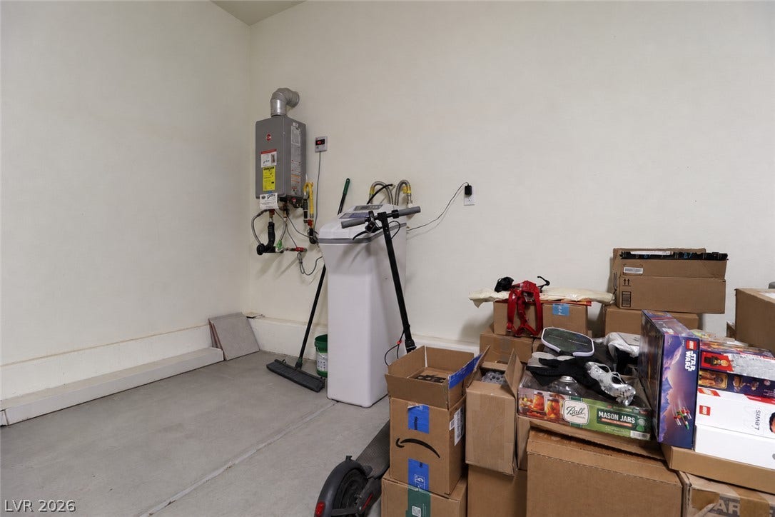A functional utility space features durable concrete flooring.