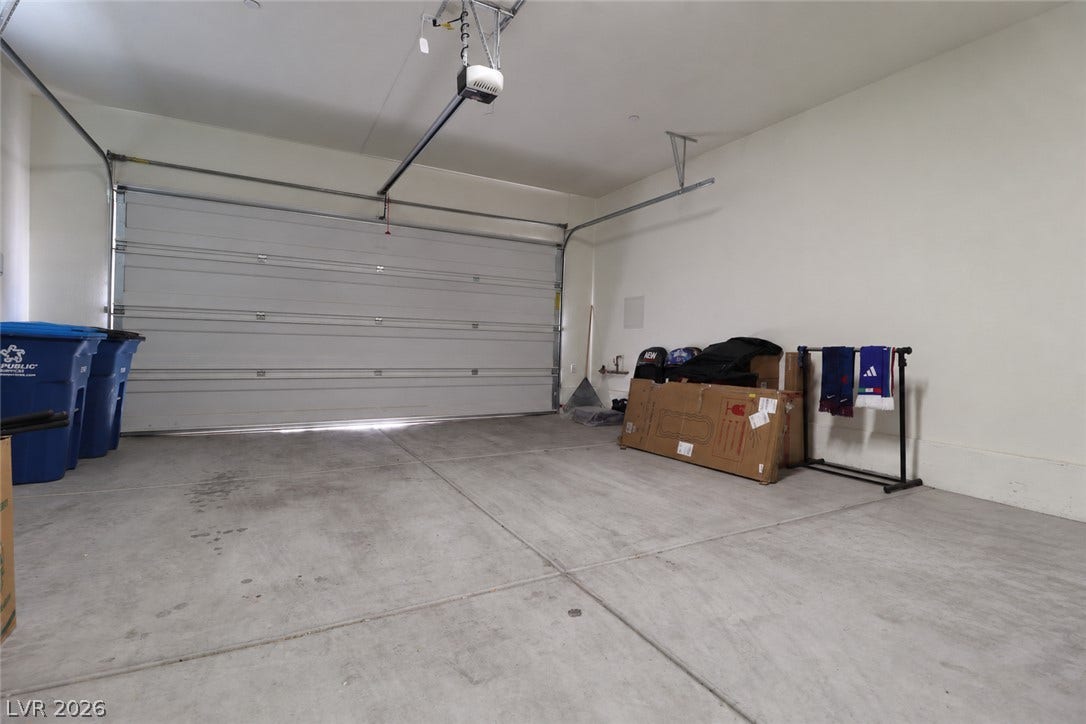 Concrete flooring and high ceilings define this highly functional attached garage space.