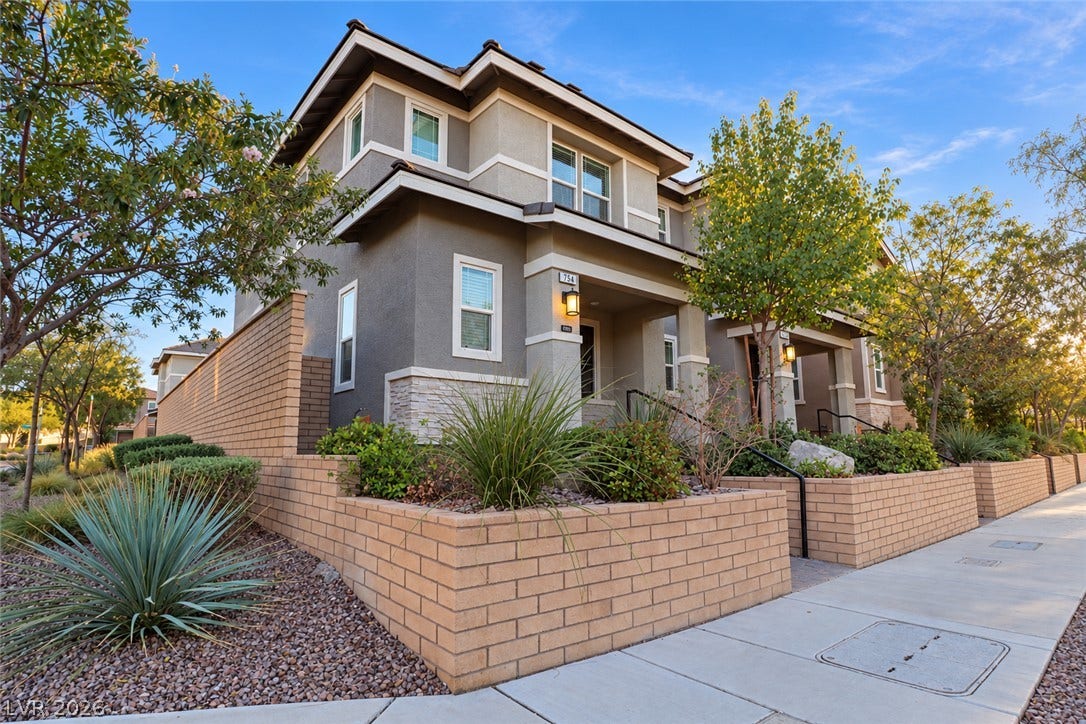 Multi-level modern architecture highlights this exterior featuring structured stone details and desert-inspired landscaping.