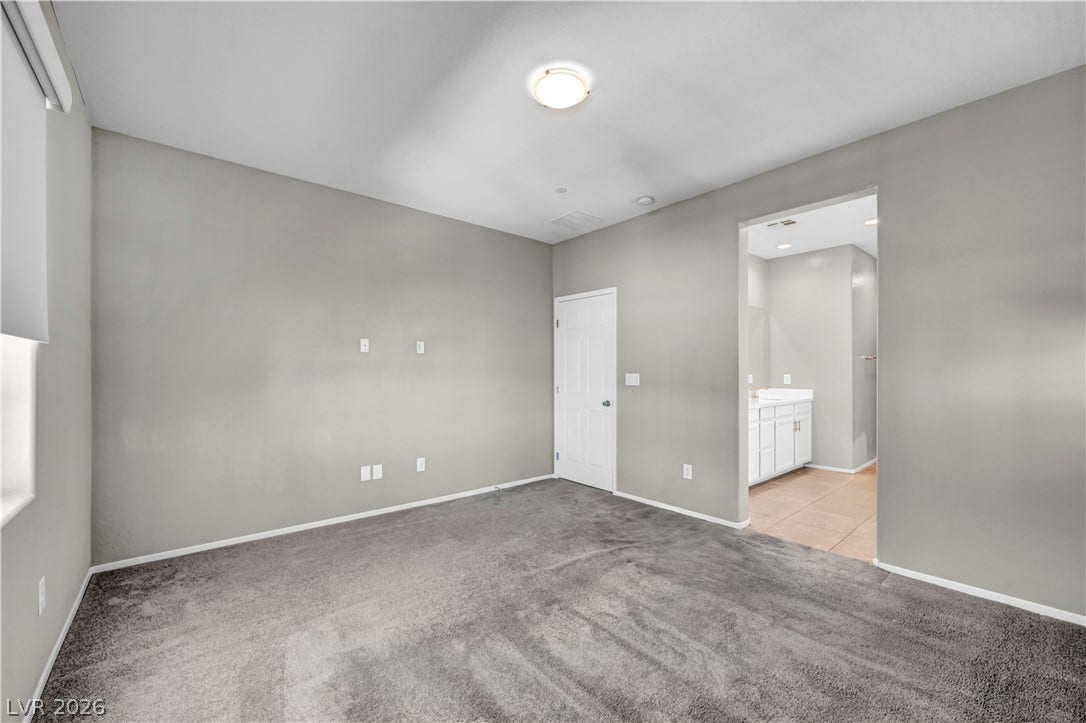8577 Insignia Avenue, #101, Las Vegas, NV 89178 Plush carpeting and an attached bathroom define this private bedroom suite.