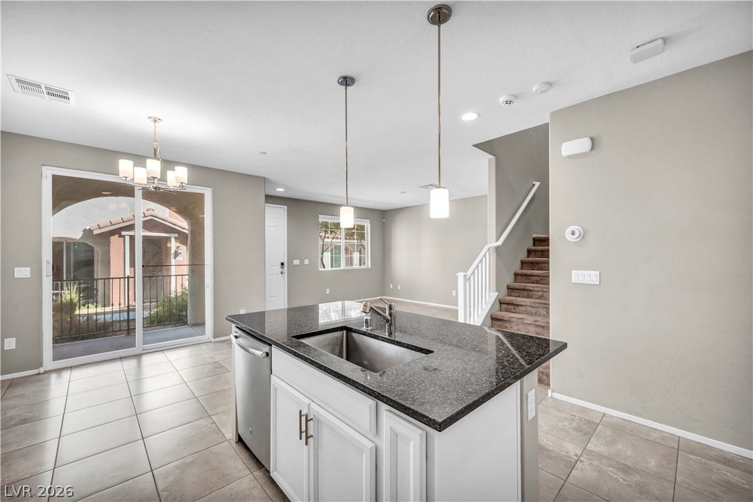 8577 Insignia Avenue, #101, Las Vegas, NV 89178 An open floorplan connects the central kitchen island to the dining area and staircase.