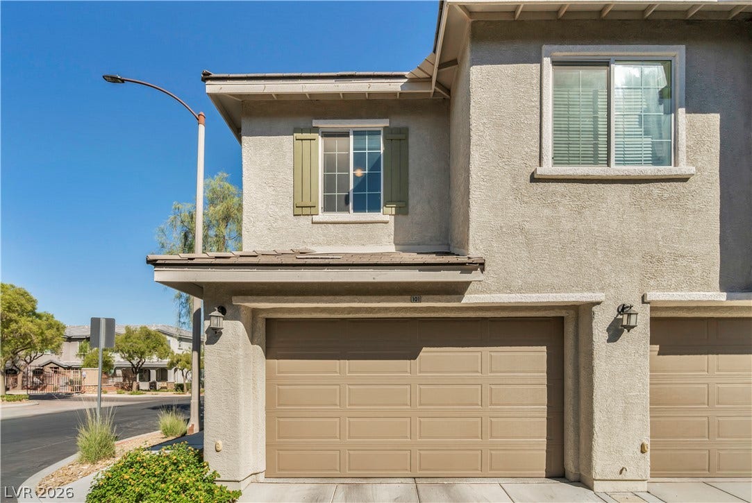 8577 Insignia Avenue, #101, Las Vegas, NV 89178 Stucco exterior elements pair with neutral tones in this multi-level residential design.