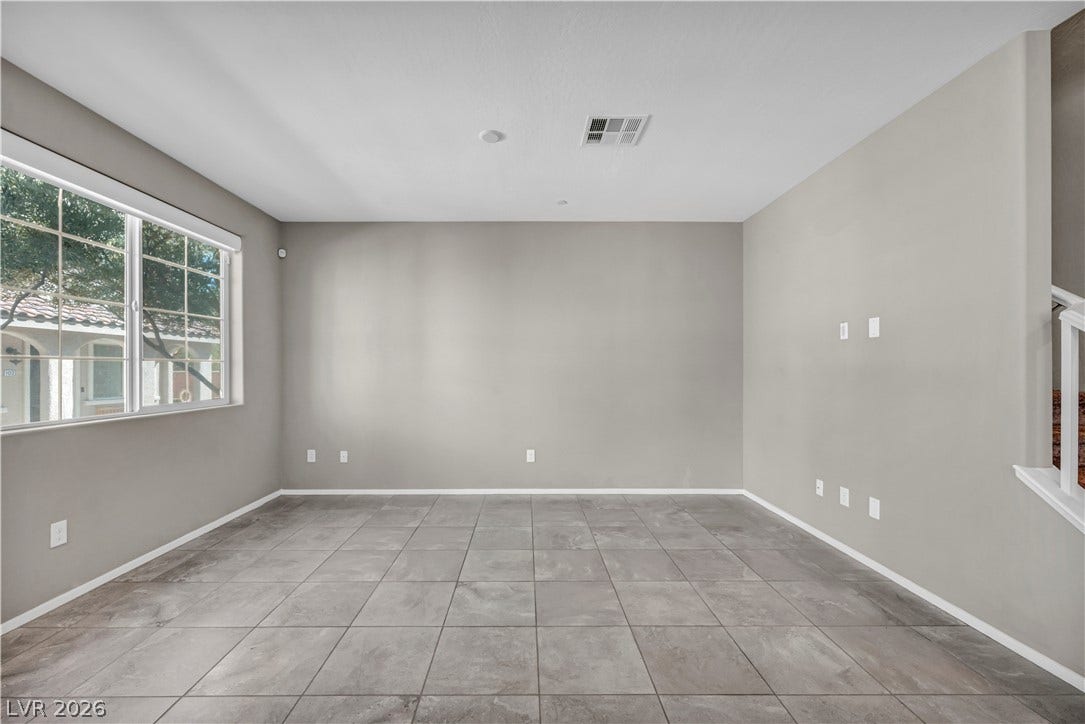 8577 Insignia Avenue, #101, Las Vegas, NV 89178 Durable tile flooring and a wide window define this versatile open living area.