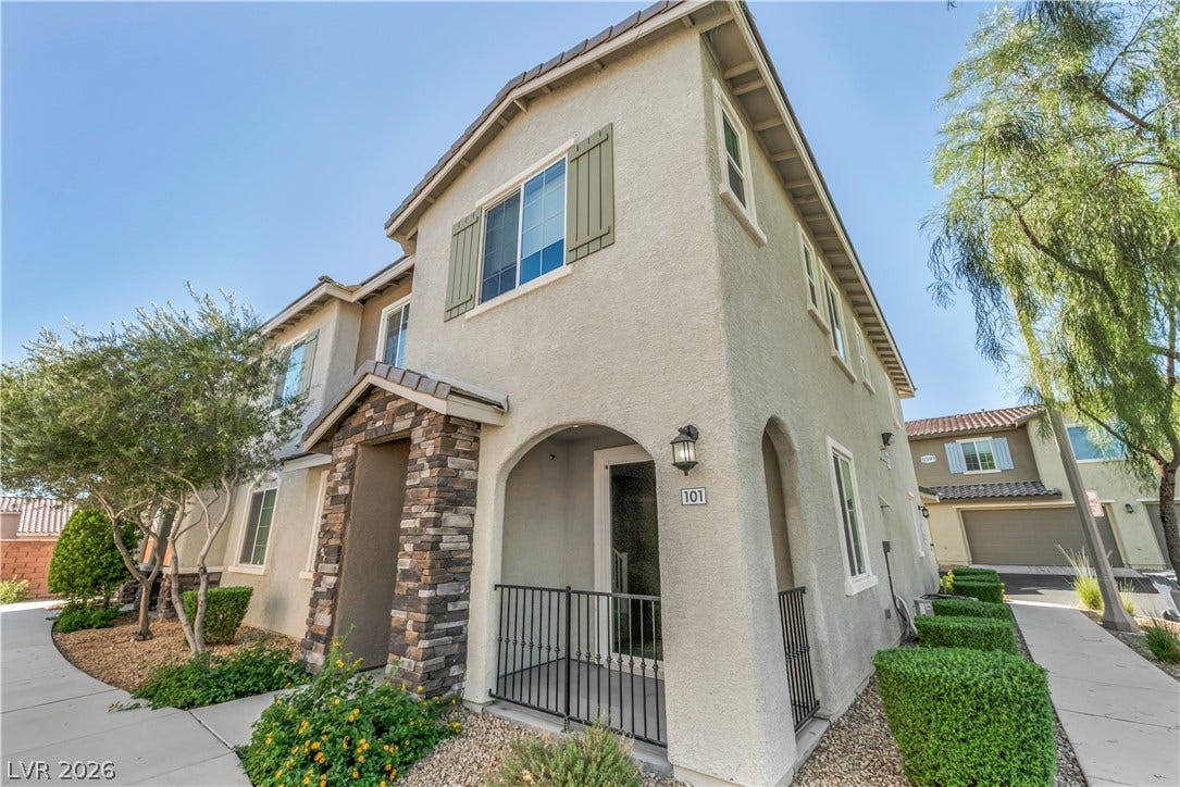 8577 Insignia Avenue, #101, Las Vegas, NV 89178 Textured stucco walls and stone accents define this inviting multi-level residential exterior.