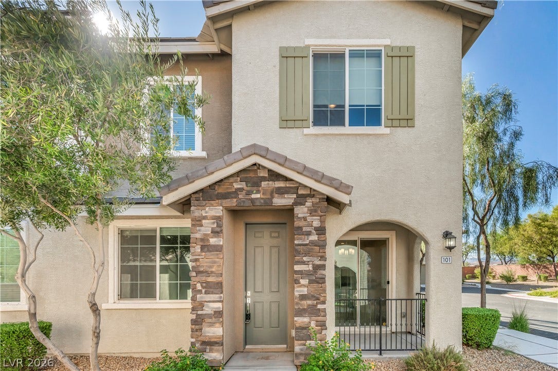 8577 Insignia Avenue, #101, Las Vegas, NV 89178 Stately stone masonry surrounds the welcoming covered entryway of this classic multi-level residence.