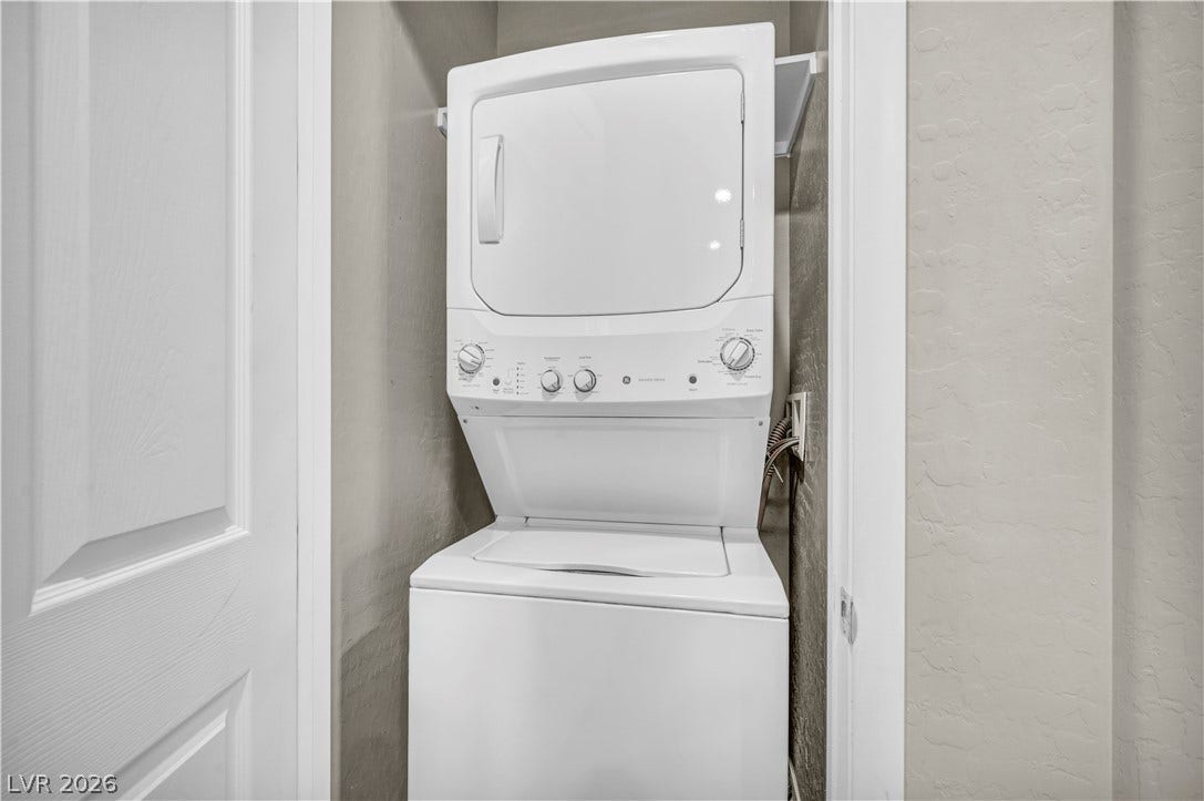 8577 Insignia Avenue, #101, Las Vegas, NV 89178 A compact laundry closet provides space-saving utility with a stacked washer and dryer setup.