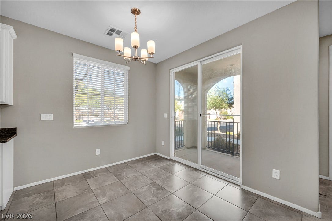 8577 Insignia Avenue, #101, Las Vegas, NV 89178 Tiled flooring and sliding glass doors leading to a private outdoor patio space.