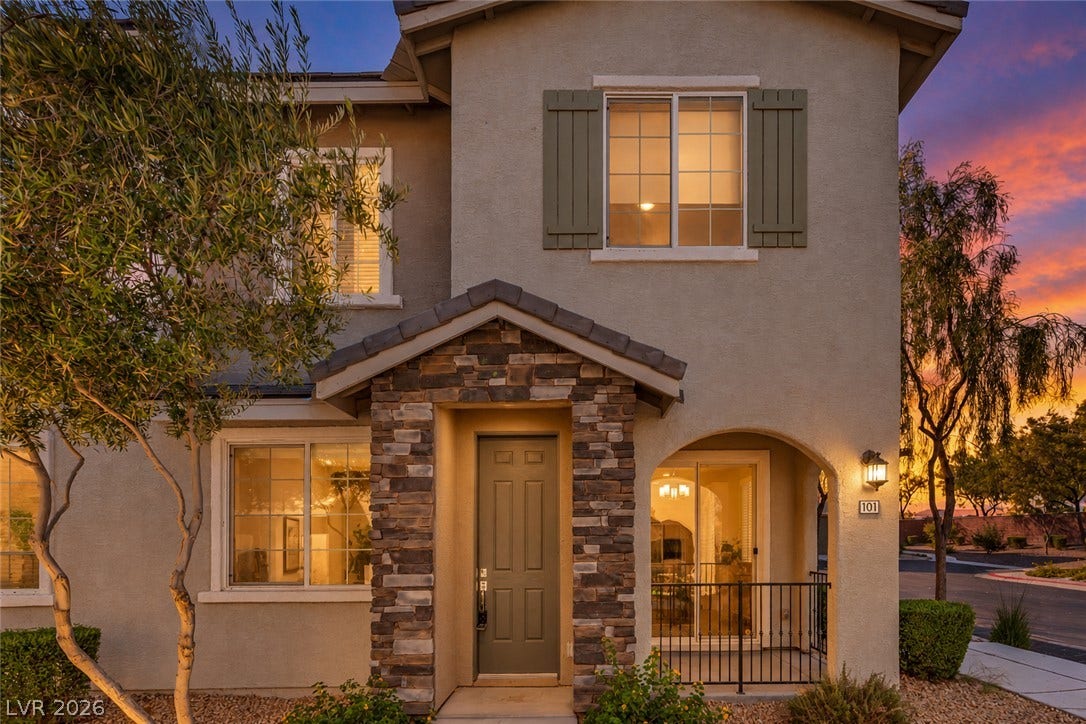 8577 Insignia Avenue, #101, Las Vegas, NV 89178 Stone accents and decorative shutters bring classic charm to this multi-level home exterior.
