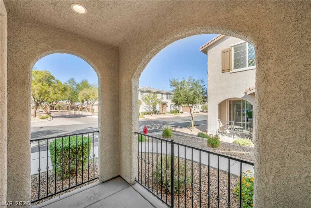 8577 Insignia Avenue, #101, Las Vegas, NV 89178 Elegant arched openings framing neighborhood views from the covered concrete entryway.