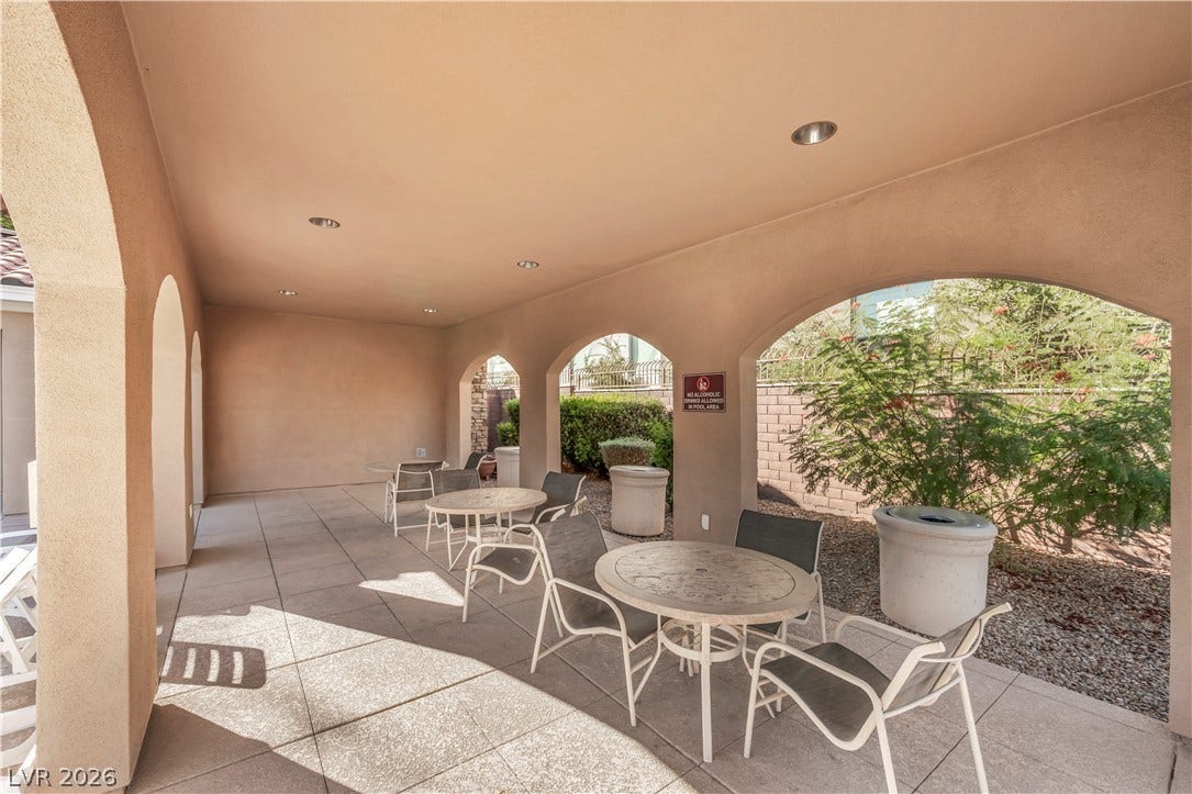 8577 Insignia Avenue, #101, Las Vegas, NV 89178 Shaded concrete patio features elegant stucco arches opening to the landscaped grounds.