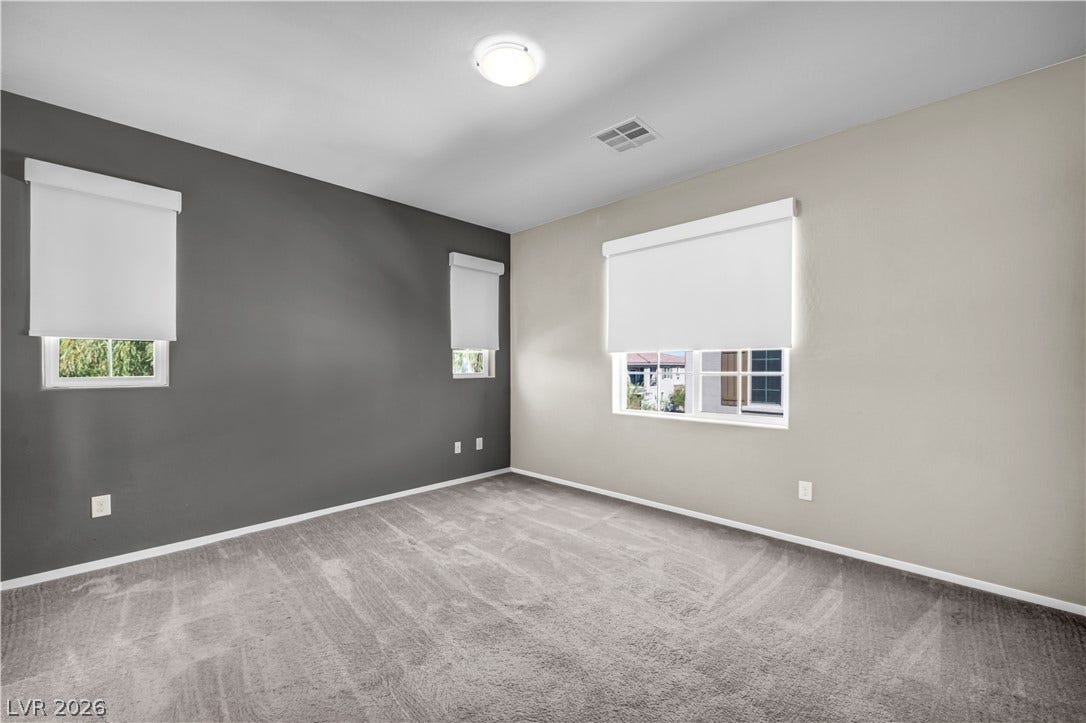 8577 Insignia Avenue, #101, Las Vegas, NV 89178 Plush carpeting anchors this versatile room illuminated by multiple windows.