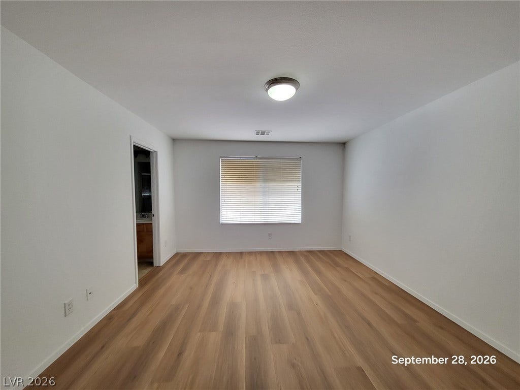 7619 Good Fortune Court, Las Vegas, NV 89139 Gleaming wood floors anchor this clean room illuminated by natural light.