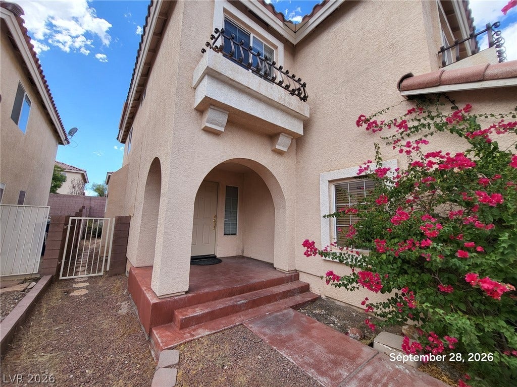 7619 Good Fortune Court, Las Vegas, NV 89139 Arched architectural details and a private balcony accent this stucco exterior entryway.