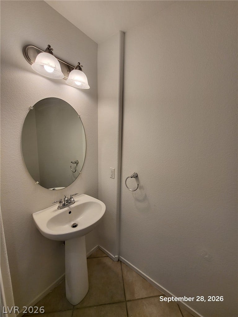 7619 Good Fortune Court, Las Vegas, NV 89139 A classic pedestal sink pairs with tile flooring in this functional half bath.