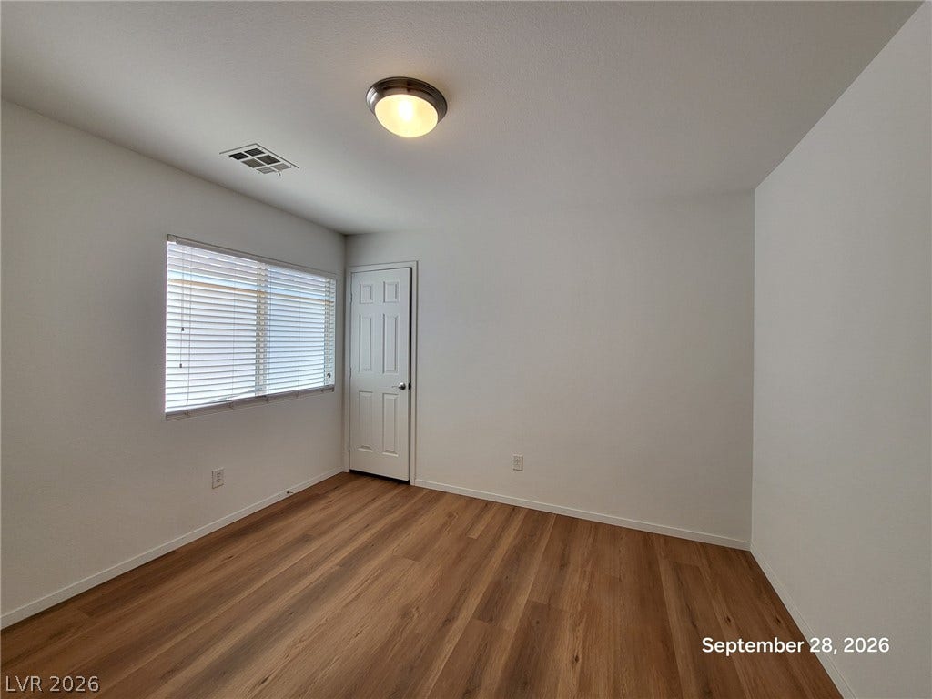 7619 Good Fortune Court, Las Vegas, NV 89139 Warm wood flooring and clean white walls create a versatile canvas in this bedroom.