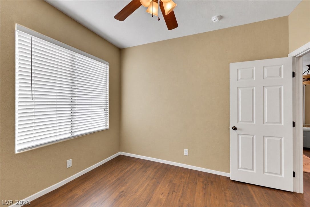 Second bedroom located upstairs featuring ceiling fan, ceiling light, mirrored wall closet. (AI used to remove items from space).
